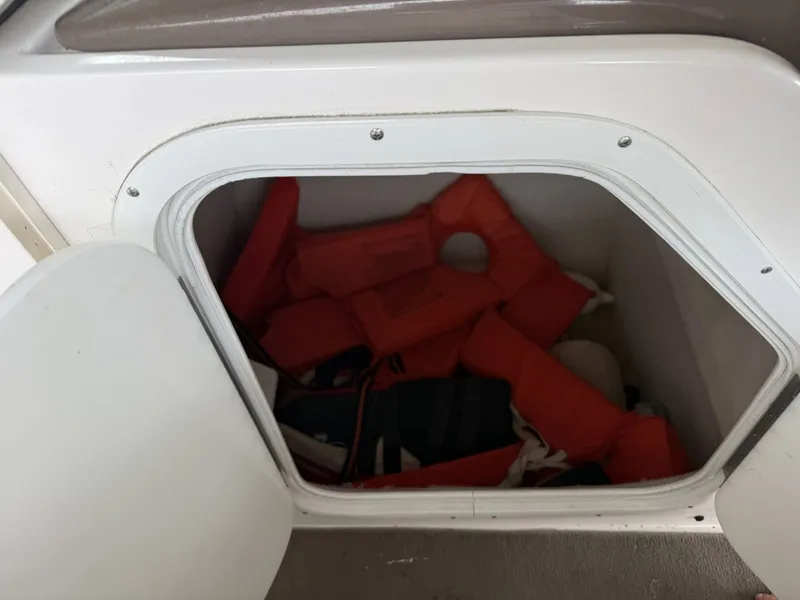 Slide: The Image of Regal 2900 BR 2005 boat with life jackets in storage compartment. - 12