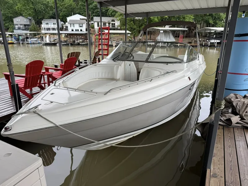 The Image of 2005 Regal 2900 BR boat docked, surrounded by water and houses. - 13