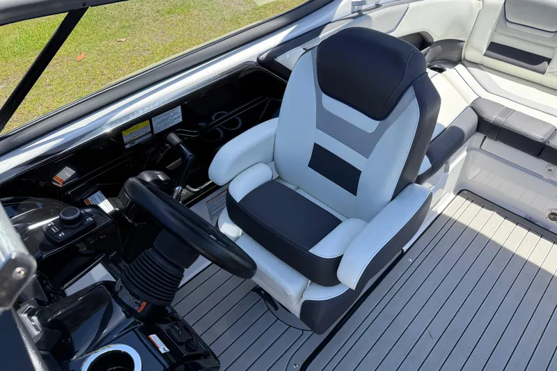 Slide: The Image of 2020 Yamaha Boats 212S interior with sleek captain's chair and modern steering controls. - 17