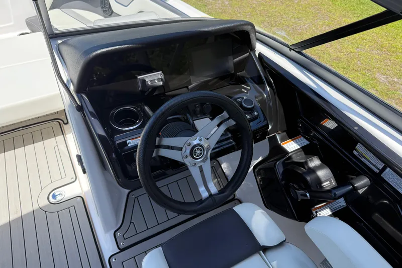 Slide: The Image of 2020 Yamaha Boats 212S cockpit with steering wheel and control panel. - 19