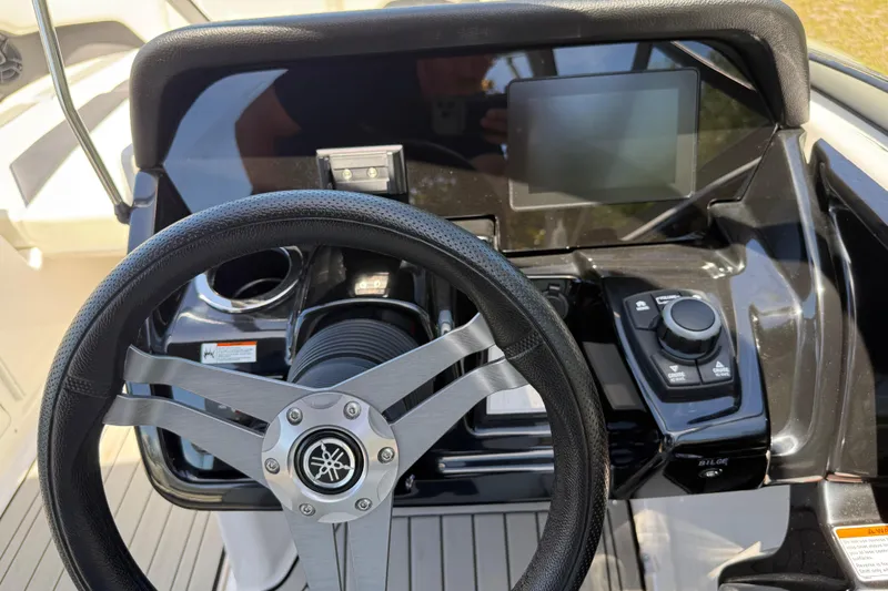 Slide: The Image of 2020 Yamaha Boats 212S dashboard with steering wheel and control panel. - 20