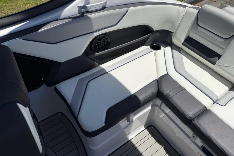 Slide: The Image of 2020 Yamaha Boats 212S interior seating with sleek, modern design and integrated speaker. - 23