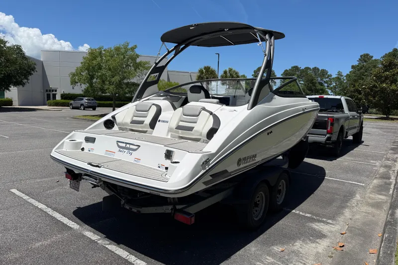 Slide: The Image of 2020 Yamaha Boats 212S on trailer in parking lot, sunny day. - 6