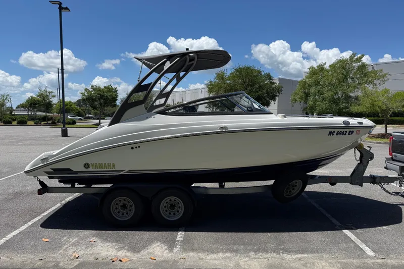 Slide: The Image of 2020 Yamaha Boats 212S on trailer in sunny parking lot. - 7