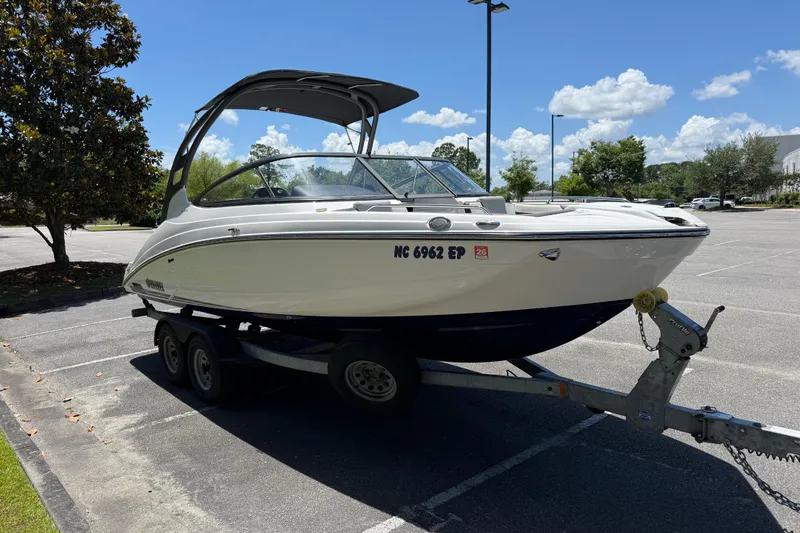 Slide: The Image of 2020 Yamaha Boats 212S on trailer in sunny parking lot. - 8
