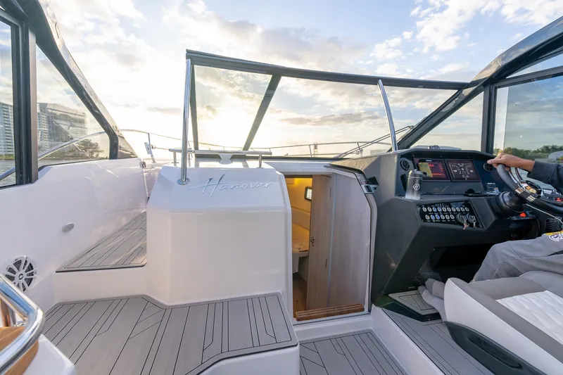 Slide: The Image of Interior view of 2027 Hanover 387 boat cockpit with modern controls and seating. - 12