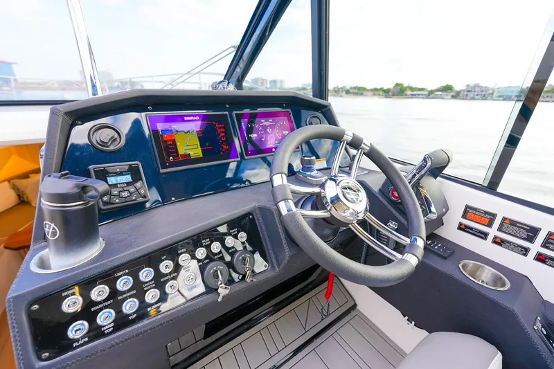 Slide: The Image of Helm of 2027 Hanover 387 boat with advanced navigation displays and controls. - 13