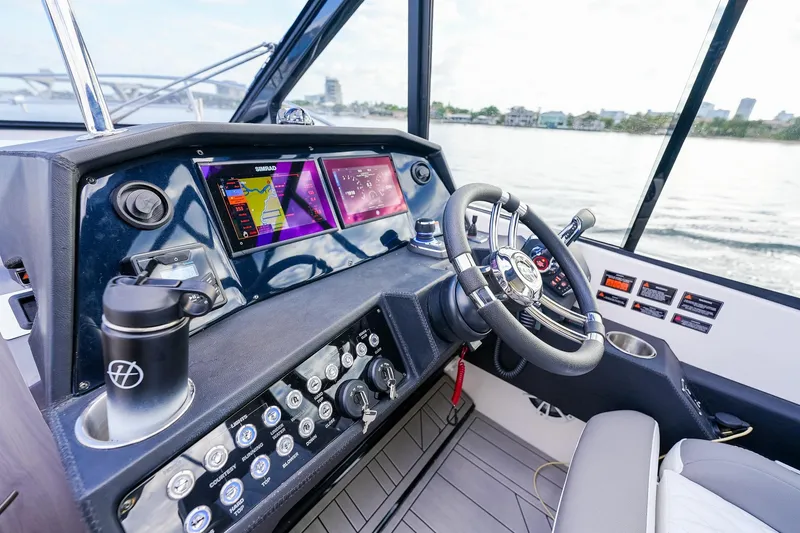 Slide: The Image of Modern helm of 2027 Hanover 387 boat with advanced navigation displays and controls. - 14