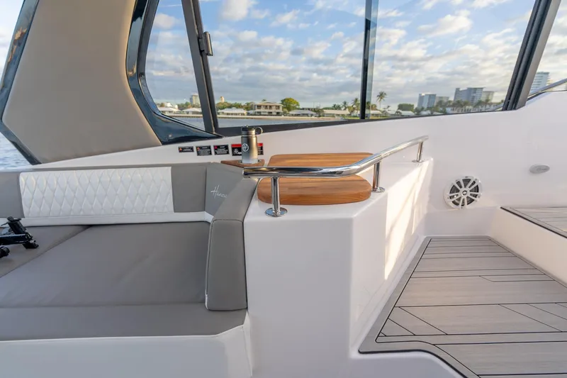 Slide: The Image of Luxurious interior of 2027 Hanover 387 yacht with modern seating and scenic view. - 18