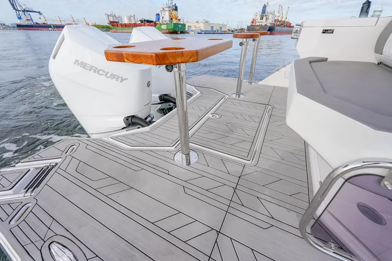 Slide: The Image of ```json { "alt_text": "2027 Hanover 387 boat deck with Mercury engine and seating area." } ``` - 19