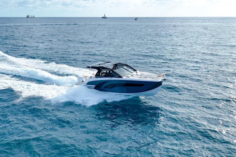Slide: The Image of A 2027 Hanover 387 yacht cruising on open blue ocean waters. - 2