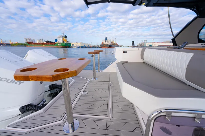 Slide: The Image of Luxurious Hanover 387 boat deck with seating and table, overlooking a bustling harbor. - 25