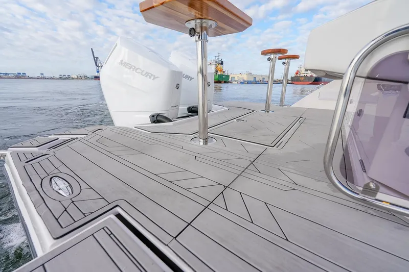 Slide: The Image of Luxury Hanover 387 boat deck with Mercury engines, 2027 model, docked at a bustling harbor. - 26