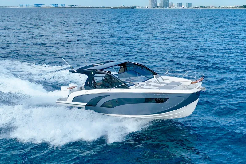 Slide: The Image of Luxury Hanover 387 yacht cruising on open sea, 2027 model, with city skyline in background. - 4