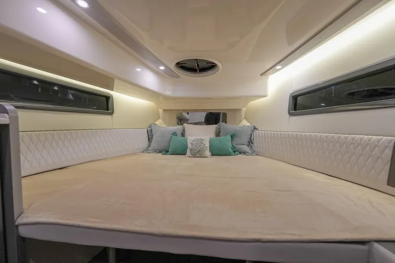 Slide: The Image of Luxurious interior cabin of 2027 Hanover 387 yacht with plush bedding and ambient lighting. - 40