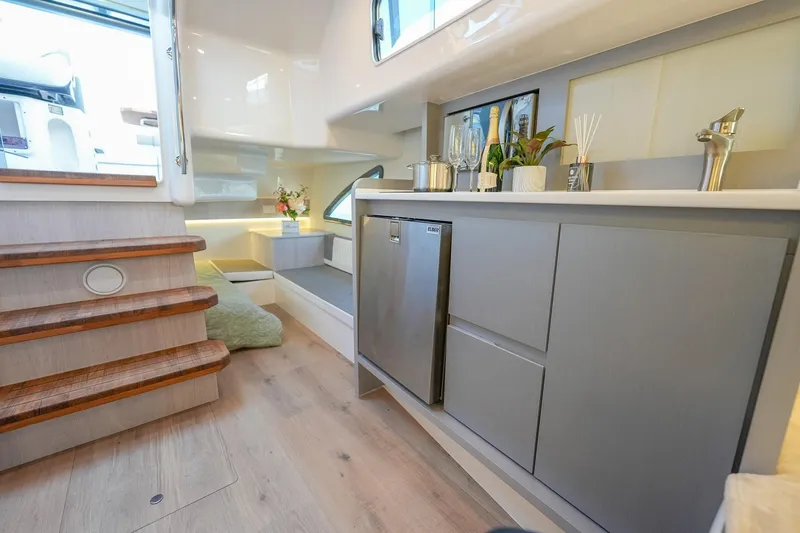 Slide: The Image of Luxurious interior of 2027 Hanover 387 yacht with modern kitchenette and elegant decor. - 41