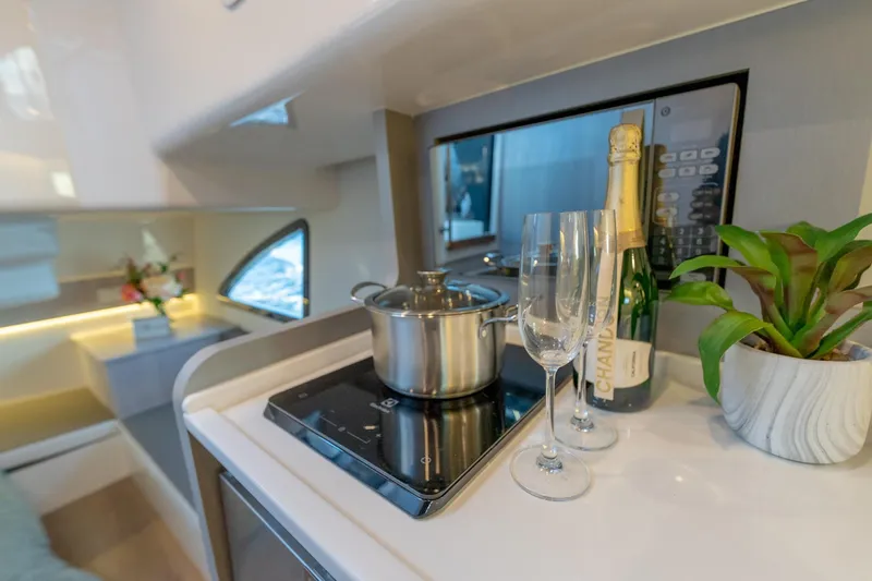 Slide: The Image of Modern kitchen interior in 2027 Hanover 387 yacht with champagne, glasses, and cookware. - 43