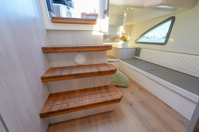 Slide: The Image of Interior of 2027 Hanover 387 boat with wooden steps and modern seating area. - 45