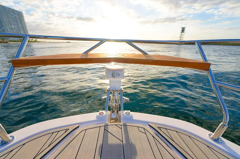 Slide: The Image of Bow view of 2027 Hanover 387 yacht on serene water at sunset. - 7