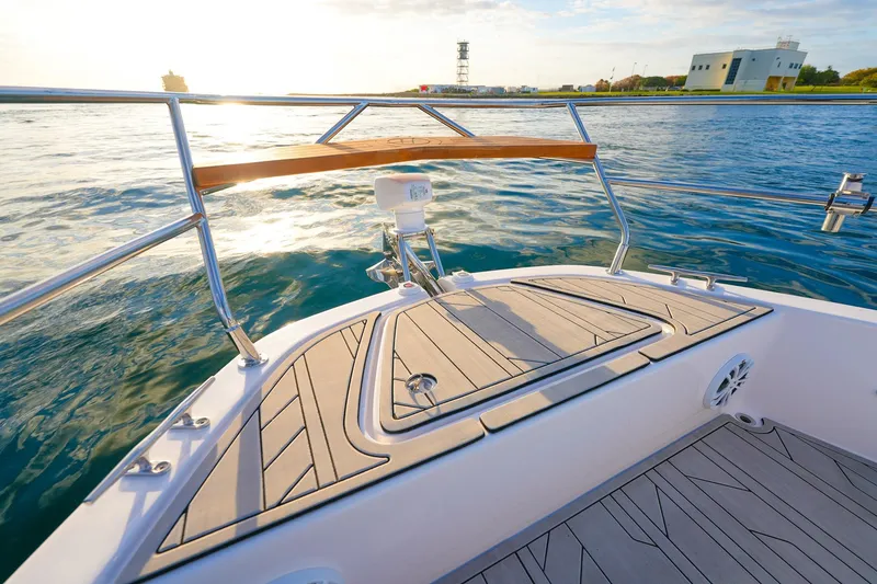 Slide: The Image of Bow view of 2027 Hanover 387 boat on calm water near shoreline. - 8