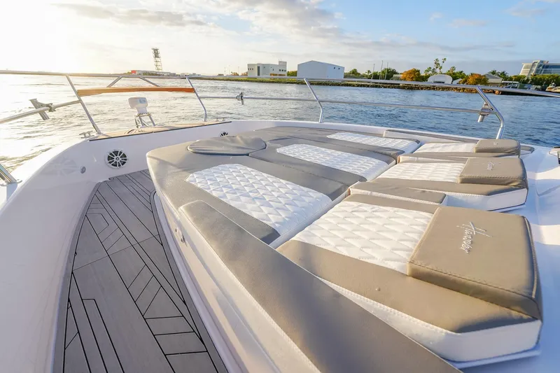 Slide: The Image of Luxurious Hanover 387 yacht deck with cushioned seating, overlooking serene waters at sunset. - 9