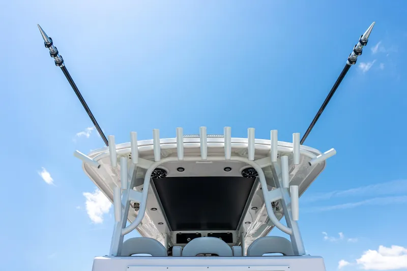 Slide: The Image of Twin Vee 400 GFX2 CC 2026 boat with fishing rod holders against a clear blue sky. - 13