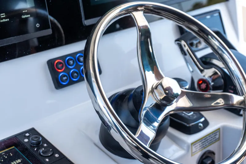 Slide: The Image of Steering wheel of 2026 Twin Vee 400 GFX2 CC boat with modern controls. - 16