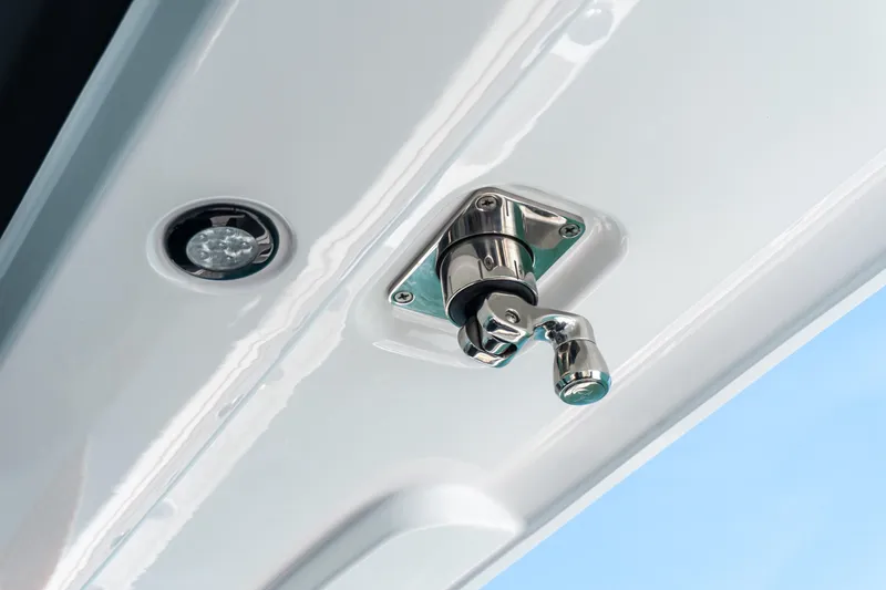 Slide: The Image of Close-up of a 2026 Twin Vee 400 GFX2 CC boat latch and light fixture. - 17