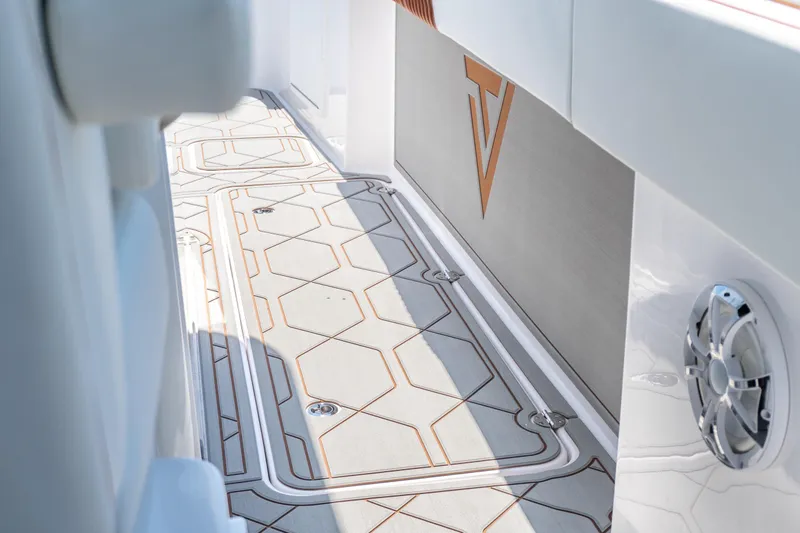Slide: The Image of 2026 Twin Vee 400 GFX2 CC boat interior with sleek flooring and modern design elements. - 19