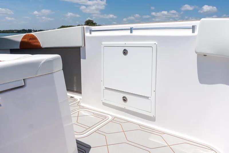 Slide: The Image of Interior view of 2026 Twin Vee 400 GFX2 CC boat, featuring sleek white seating and storage. - 20