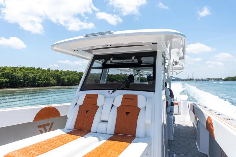 Slide: The Image of 2026 Twin Vee 400 GFX2 CC boat cruising on a sunny day, featuring luxurious seating. - 26