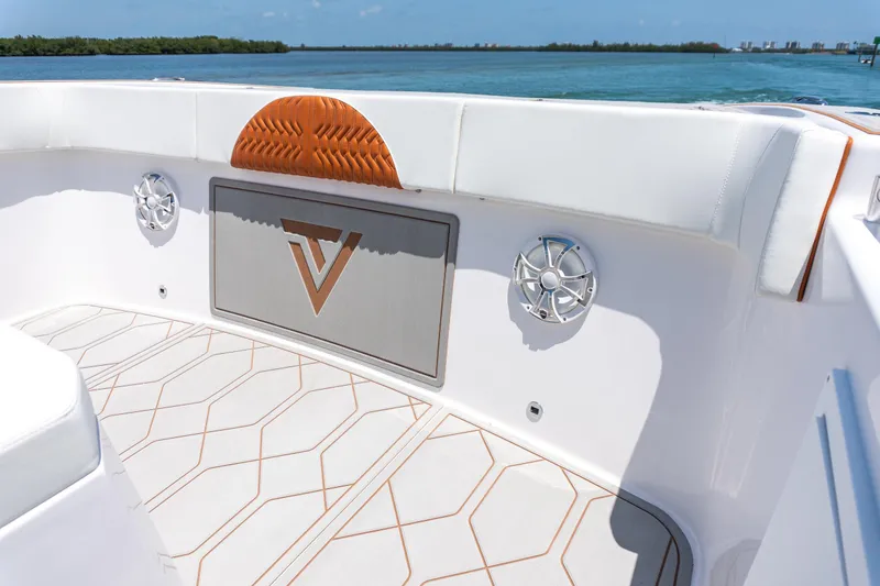 Slide: The Image of 2026 Twin Vee 400 GFX2 CC boat interior with stylish seating and speakers. - 32