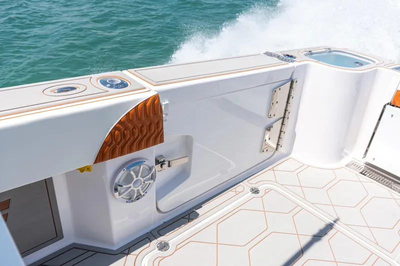 Slide: The Image of 2026 Twin Vee 400 GFX2 CC boat interior with sleek design and ocean backdrop. - 38