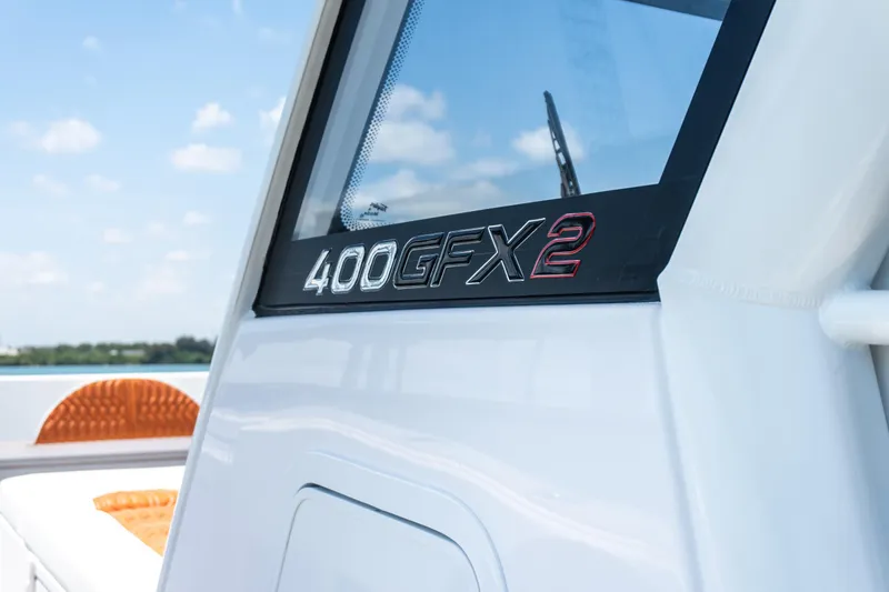 Slide: The Image of Close-up of 2026 Twin Vee 400 GFX2 CC boat model name on white exterior. - 41