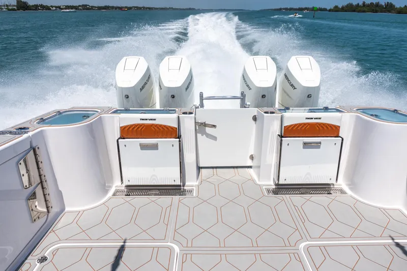 Slide: The Image of 2026 Twin Vee 400 GFX2 CC boat with four powerful Mercury engines on open water. - 42