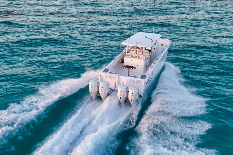 Slide: The Image of Twin Vee 400 GFX2 CC 2026 cruising on open water with triple engines. - 44