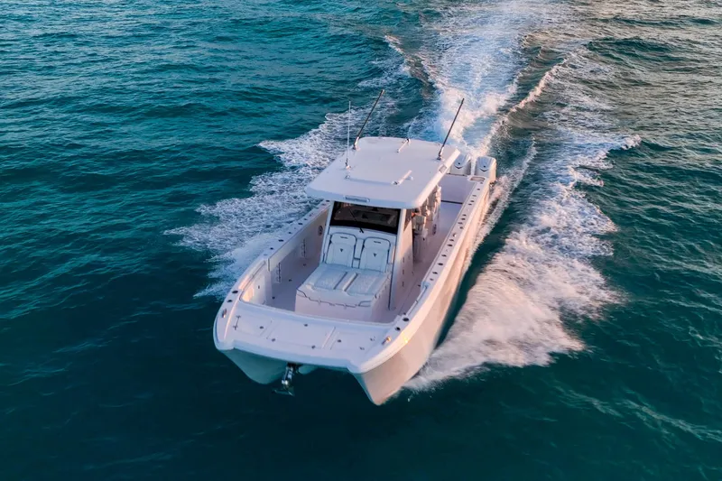 Slide: The Image of 2026 Twin Vee 400 GFX2 CC cruising on open water, aerial view. - 5