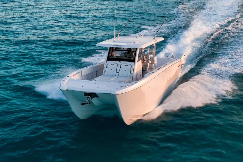 Slide: The Image of 2026 Twin Vee 400 GFX2 CC cruising on open water, showcasing sleek design and performance. - 6