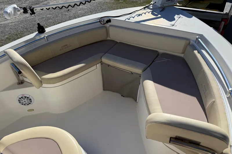 Slide: The Image of 2018 Cobia 220 Center Console boat interior with cushioned seating and storage. - 13