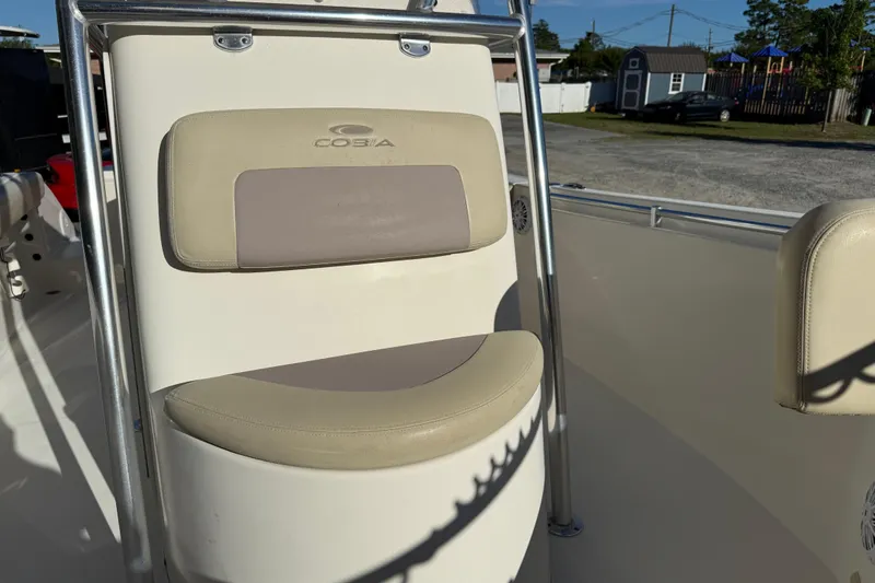 Slide: The Image of 2018 Cobia 220 Center Console boat seat with beige and gray upholstery. - 16