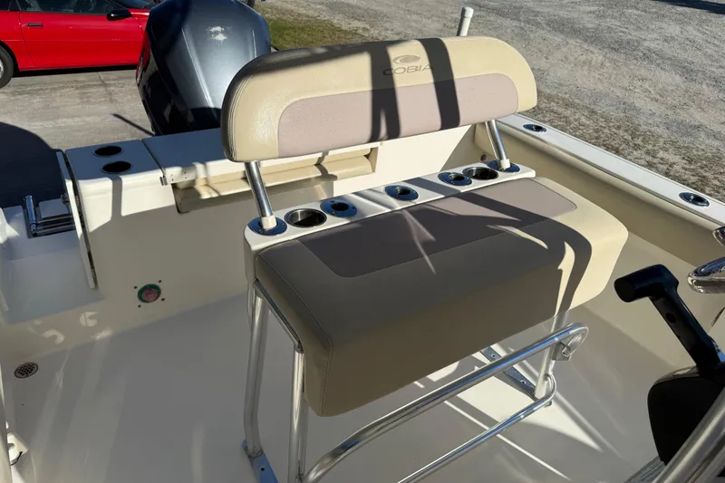 Slide: The Image of 2018 Cobia 220 Center Console boat interior with seating and cup holders. - 18