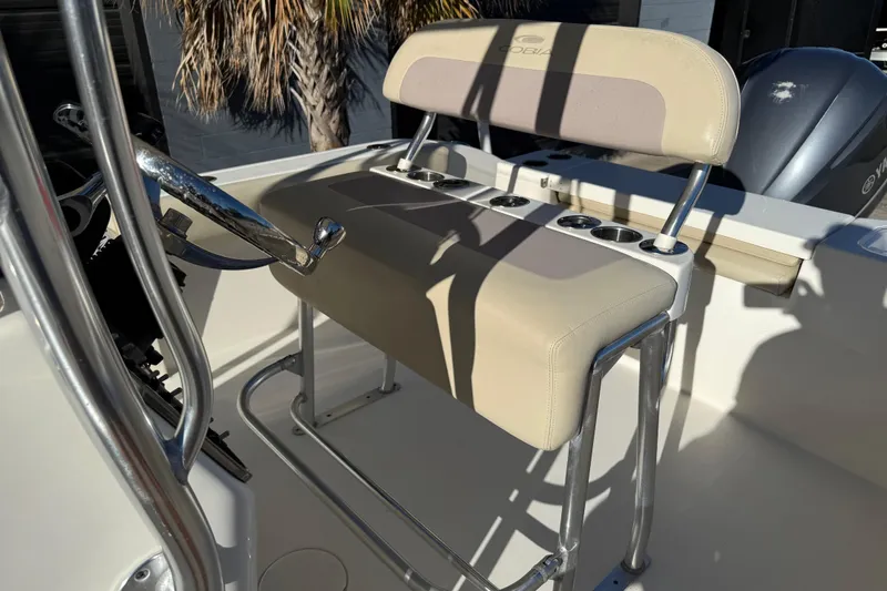 Slide: The Image of 2018 Cobia 220 Center Console boat interior with steering wheel and cushioned seating. - 19