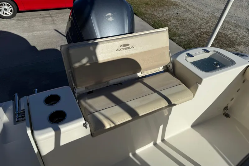 Slide: The Image of 2018 Cobia 220 Center Console boat interior with seating and storage compartments. - 20