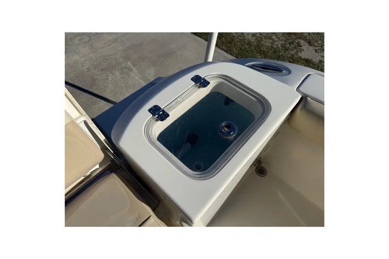Slide: The Image of 2018 Cobia 220 Center Console livewell with clear lid and secure latches. - 22