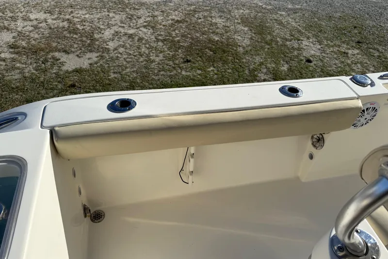Slide: The Image of 2018 Cobia 220 Center Console boat interior with rod holders and seating. - 23