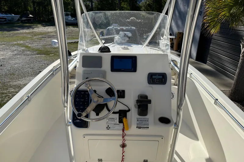 Slide: The Image of 2018 Cobia 220 Center Console boat dashboard with steering wheel and navigation equipment. - 24
