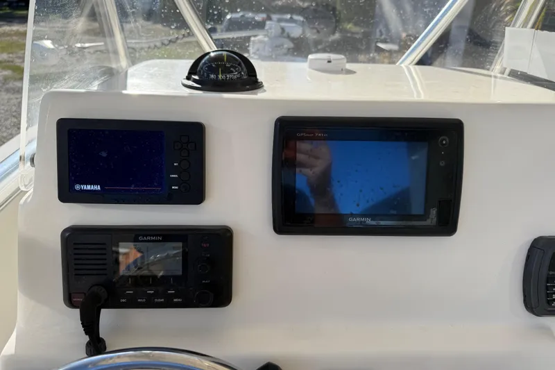 Slide: The Image of Dashboard of a 2018 Cobia 220 Center Console with Yamaha and Garmin displays. - 25