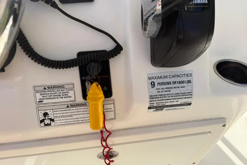 Slide: The Image of Control panel of a 2018 Cobia 220 Center Console boat with safety warnings. - 28