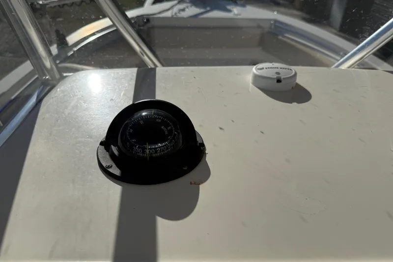 Slide: The Image of Compass on 2018 Cobia 220 Center Console boat dashboard in sunlight. - 29