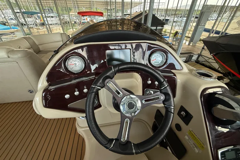 Slide: The Image of Steering console of a 2016 Starcraft MX 25 DL boat with gauges and controls. - 11